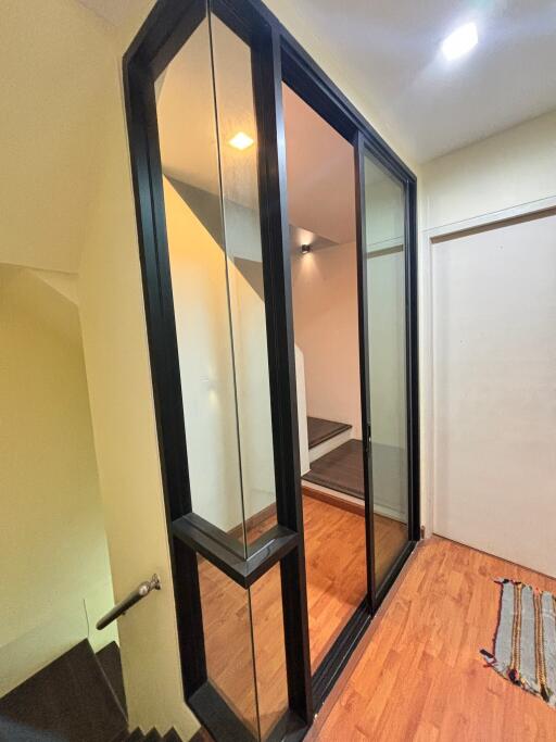 Modern stairwell with glass panels and wooden flooring