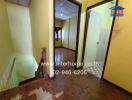 Interior hallway with stairwell and adjacent room