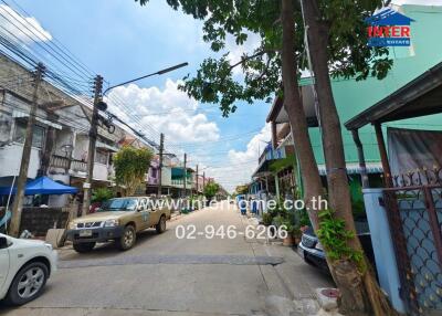 Street view of a residential area with cars parked on either side