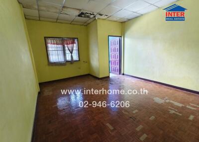 Bedroom with wooden floor and yellow walls