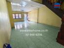 Spacious living room with tiled flooring and staircase