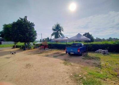 Outdoor area with tents and a blue pickup truck