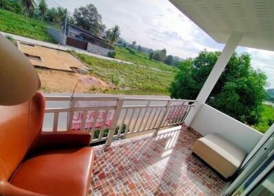 Outdoor balcony with seating and scenic view