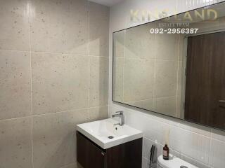 Modern bathroom with large mirror and single sink vanity