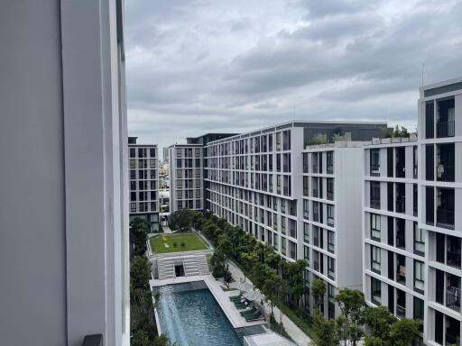 Modern residential apartment buildings with a pool and greenery