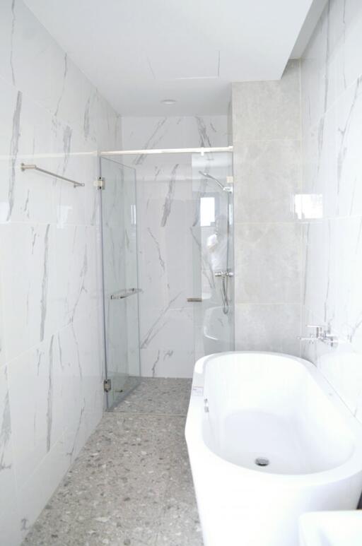 Modern bathroom with marble tiles and glass shower