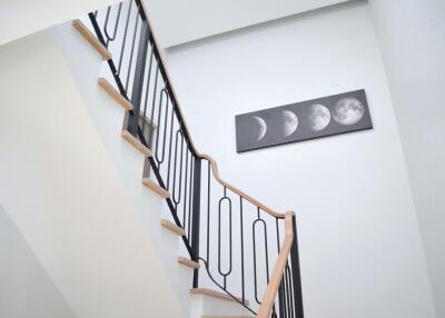 Modern staircase with moon phase artwork