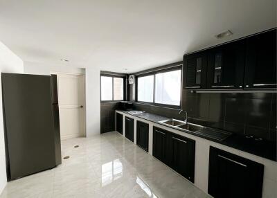 Modern kitchen with black cabinets and stainless steel appliances