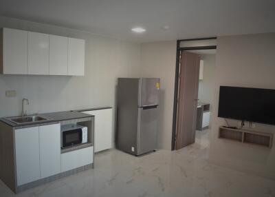 Modern kitchen with appliances and adjacent living area