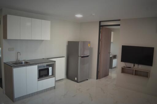 Modern kitchen with appliances and adjacent living area