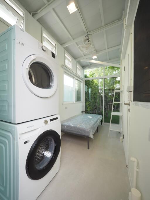 Bright laundry room with stacked washer and dryer