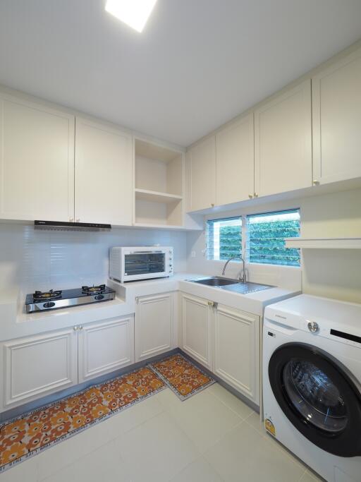 Modern kitchen with white cabinets and appliances