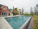 Swimming pool with adjacent houses and garden