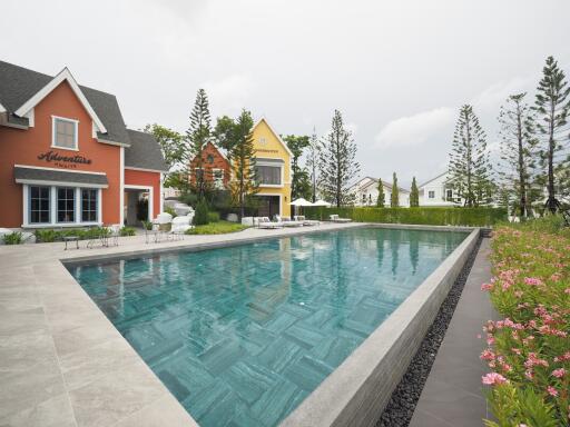 Swimming pool with adjacent houses and garden