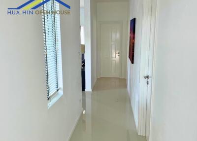 Bright clean hallway with glossy floor and side window