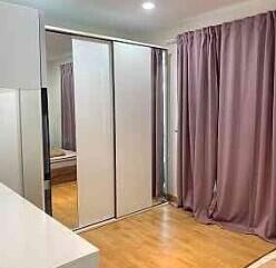 Bedroom with mirrored sliding closet doors and curtains