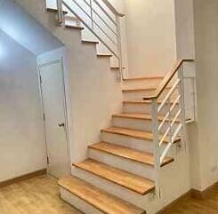 Staircase with wooden steps and white railing