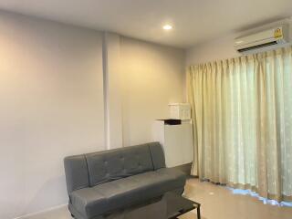 Living room with grey sofa and air conditioner