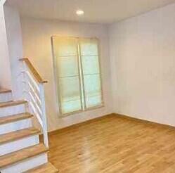 Main living area with wooden floor and staircase