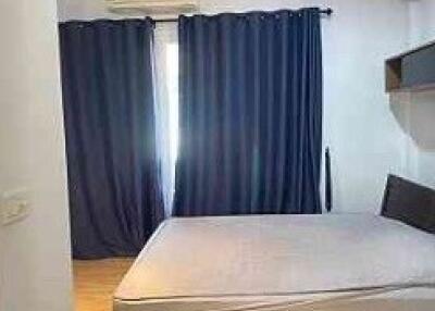 Bedroom with curtains, bed frame, and air conditioning unit