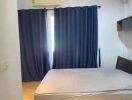 Bedroom with curtains, bed frame, and air conditioning unit