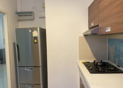 Modern kitchen with stainless steel fridge and gas stove