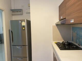 Modern kitchen with stainless steel fridge and gas stove