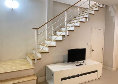 Living area with modern staircase