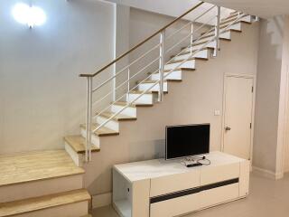 Living area with modern staircase