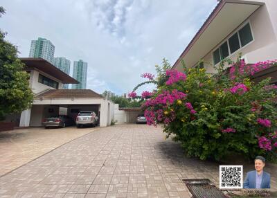 Exterior view of the property with garden and parking