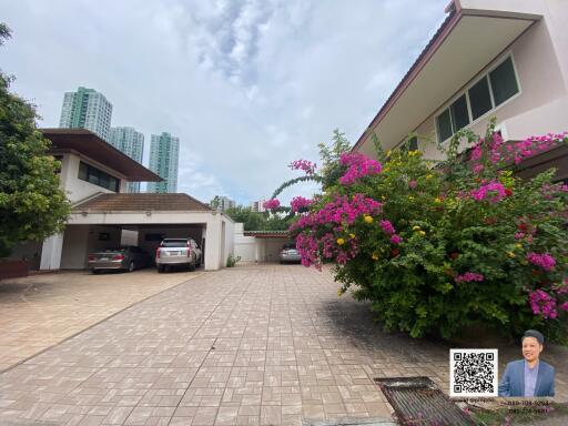 Exterior view of the property with garden and parking