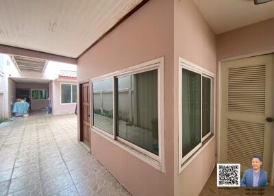 Covered outdoor corridor with tiled floor and side windows