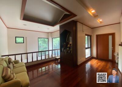 Spacious living room with wooden flooring and large windows