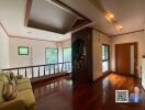 Spacious living room with wooden flooring and large windows