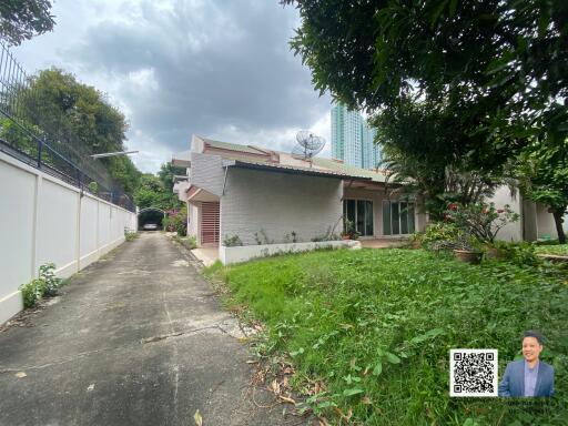 Front view of a house with a driveway and garden