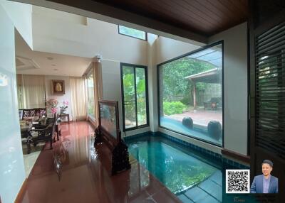 Spacious living area with indoor pool and dining area