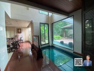 Spacious living area with indoor pool and dining area