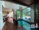 Spacious living area with indoor pool and dining area