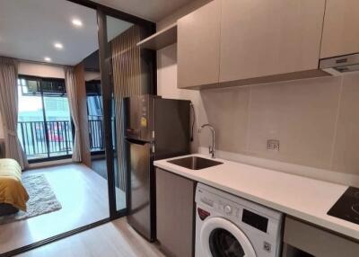 Modern kitchen with appliances and adjoining living space