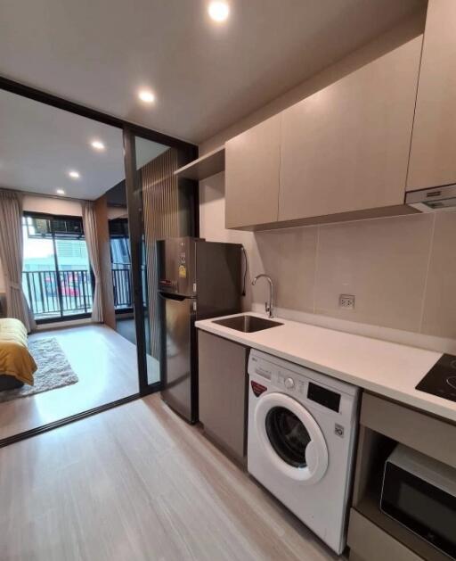 Modern kitchen with appliances and adjoining living space