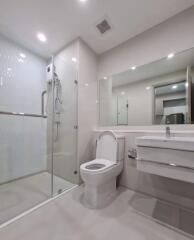 Modern bathroom with glass shower enclosure and wall-mounted fixtures