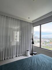 Bedroom with large window and city view