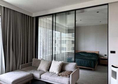 Modern living room with floor-to-ceiling windows and adjacent bedroom