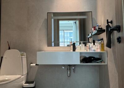 Modern bathroom with sink, toilet, and mirror