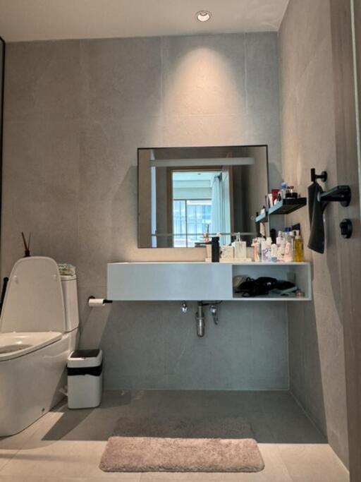 Modern bathroom with sink, toilet, and mirror