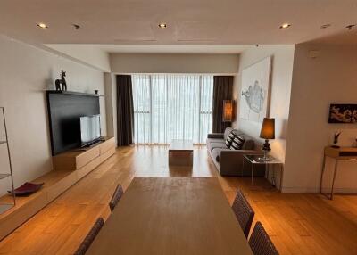 Modern living room with dining area and large window