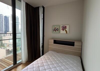 Small bedroom with a bed and balcony view