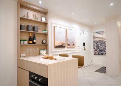 Modern kitchen with light wood cabinetry and integrated appliances