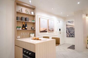 Modern kitchen with light wood cabinetry and integrated appliances