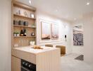 Modern kitchen with light wood cabinetry and integrated appliances